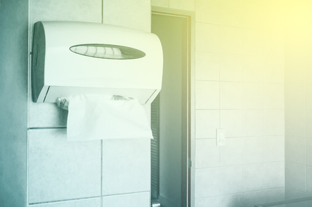 Paper towel dispenser on the wall in the toiletの写真素材