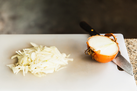 Chopped onions on cutting boardの写真素材
