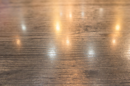Wood table and reflection of light bulbの写真素材