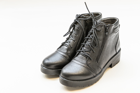Black leather ladies boots isolated on whiteの写真素材