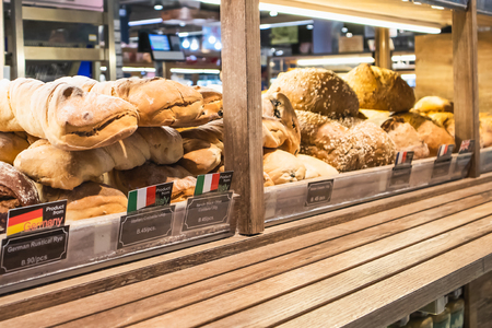 Variety of delicious breads displayed on shelves in bakery shop, Bangkok, Thailand, October 10, 2018のeditorial素材