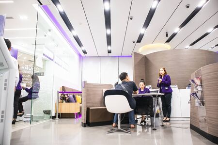 Bank employees are explaining to customers in the office at Central Department Store Bangna-Trad road Bangkok Thailand, January 20, 2019のeditorial素材
