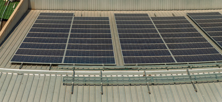 The solar panel for the production of electricity with ray of light on the roof of factory,...