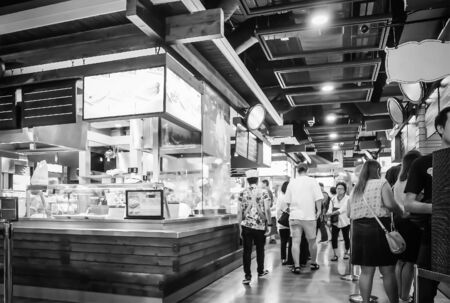 People eating and drinking in food court at Terminal 21 Department Store Asoke-Montri intersection Sukhumvit road Bangkok Thailand, April 17, 2019のeditorial素材