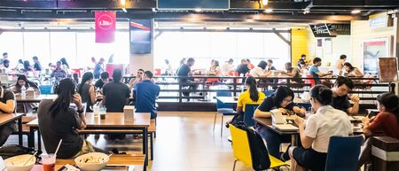 People eating and drinking in food court at Terminal 21 Department Store Asoke-Montri intersection Sukhumvit road Bangkok Thailand, April 17, 2019のeditorial素材