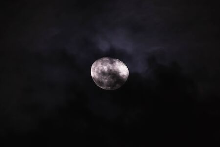 The night moon in the cloudy sky backgroundsの写真素材