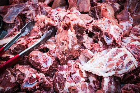Fresh pork and tongs in the supermarketの写真素材
