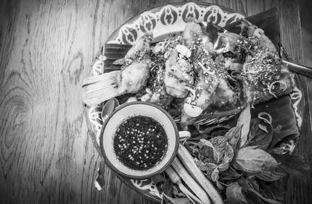 Spicy minced deep fried fish salad with vegetable on the table, Delicious Thai foodの写真素材