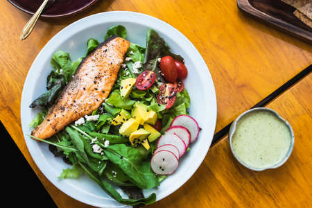 Salmon salad on the table in restaurant Bangkok