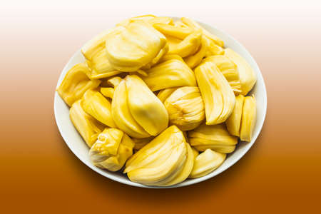 Jackfruit in a white bowl isolated on brown backgroundの写真素材