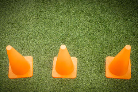Orange cones on green artificial grass, Pattern backgroundsの写真素材