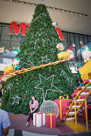 December 31, 2020, A girl takes a picture with a christmas tree in Mega Bangna Shopping Mall at Bangna-Trad road Bangna Bangkok Thailandのeditorial素材