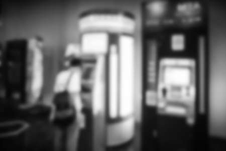 Blur or Defocus Background of Woman to Use Banking Machine or ATM(Automatic Teller Machine) to Deposit, Withdraw and Transfer Money, Bangkok Thailandの写真素材