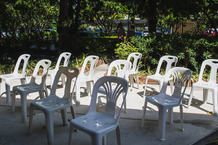 Group of white plastic chairs in the garden in natural light backgroundの写真素材