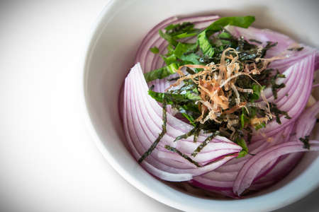 Homemade salad, Red onion topping with line fish, line seaweed and green leafy vegetables, Healthy...