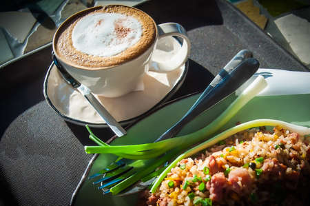Naem fried rice and cappuccino coffee on brown tray, Thai food background