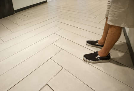 Man leaning against the wall in the hallway, Backgroundの写真素材