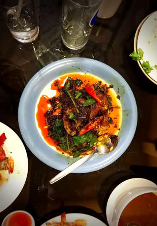 Fried fish with chili in plate on the tableの写真素材