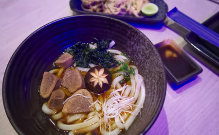 <p>Udon Soup and stewed beef tongue in a bowl, Japanese food background</p>