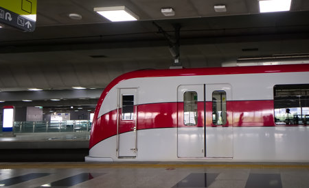 The Red Line electric train stops in Laksi Skytrain Station at Vibhavadi road Bangkok Thailandの写真素材