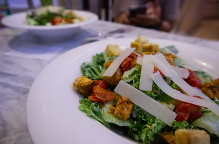 Salad on white plate on the table, healthy food backgroundの写真素材