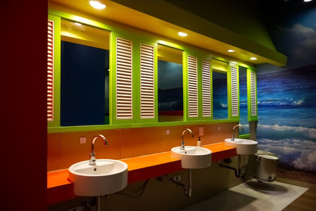 Orange and green men's restroom in a shopping mall, Bangkok, Thailandの写真素材