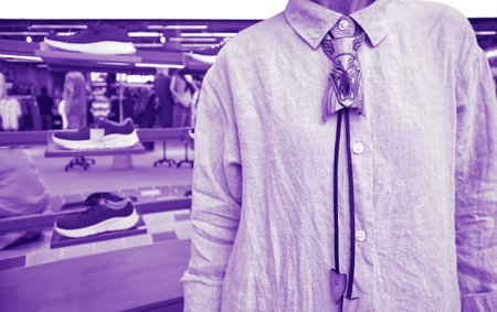 August 12, 2023, A woman ties a beautiful and unusual neck strap in shoe corner in a department...