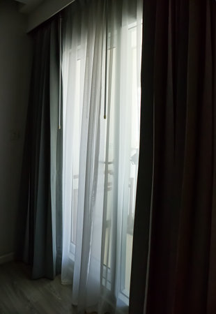 A window with natural light streaming in through the curtains, nature backgroundの写真素材