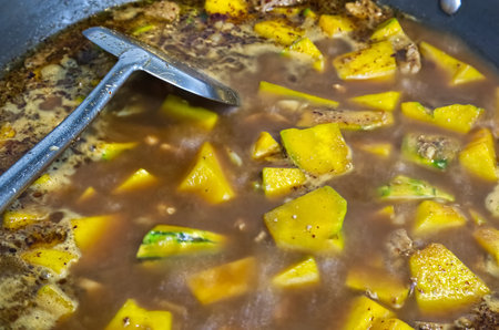 Pork and pumpkin stewed with curry in a pan, food backgroundの写真素材