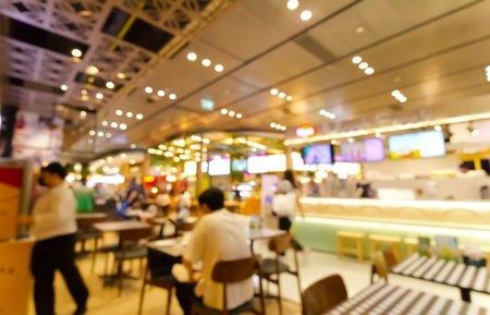 Blurred, Interior decorating of a food court with people eating and drinking in a shopping mall on Sukhumvit road Bangkok Thailandの写真素材