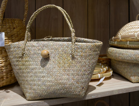 Woven tote bags on shelves in a local handicraft shop, object backgroundの写真素材