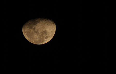 A bright crescent moon in the night sky on December 20, 2024 in Bangkok, Thailandの写真素材