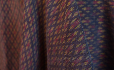 Classic red Thai fabric pattern in natural light, texture background