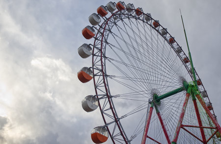 Ferris wheel with clouds and sky in the backgroundの写真素材
