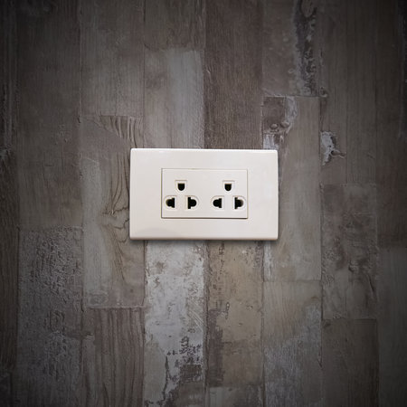 Electrical plug on old wooden wall in house, object background