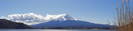 Mount Fuji surrounded by a lake with blue sky and clouds in the background in Japanの写真素材