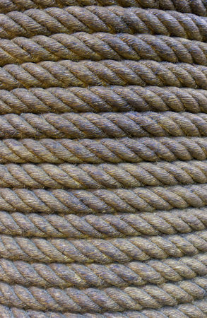 Several thick coiled ropes stacked neatly in parallel rows, Texture pattern background