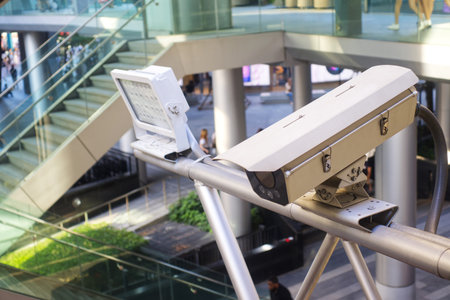 CCTV cameras with LED lights for nighttime illumination at Ratchaprasong Intersection, Bangkok, Thailandの写真素材
