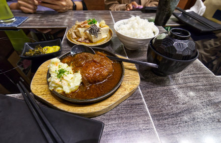 Hamburg Set and tofu with mixed ingredients on the table is a Japanese food style in Japanese restaurantsの写真素材
