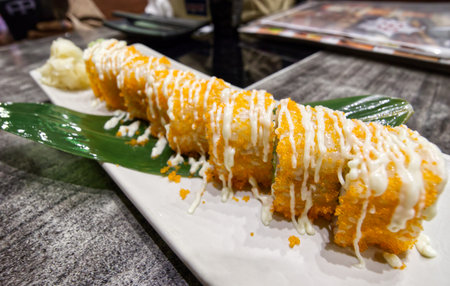 California sushi rolls on a white square plate on a table in a Japanese restaurantの写真素材