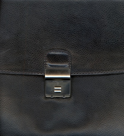 Black leather background textured with graining patterns and lockの写真素材