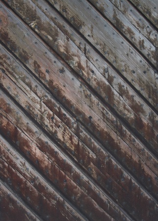 Old wooden gate with peeling paint and knotholesの写真素材
