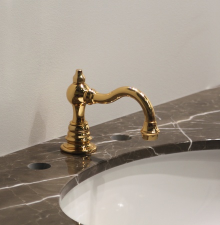 White and clean washbasin and golden tap の写真素材