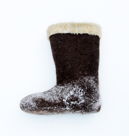 brown valenki - russian felt footwear on a snowの写真素材