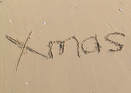 Xmas Written in sand at the beachの写真素材