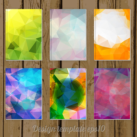 set of Abstract geometric colorful cover designs from triangular faces on wooden backgroundのイラスト素材