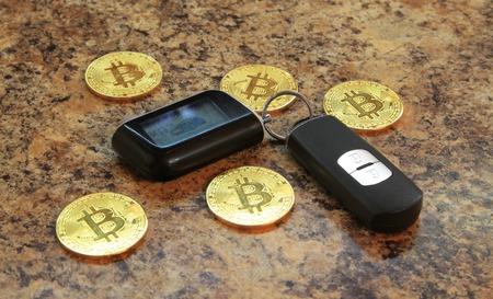 bitcoins cryptocurency with car key on the granite table