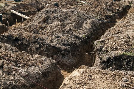 angle of the trench dug by hand under the Foundation or for laying drainageの写真素材