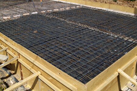 reinforcement of concrete with metal rods connected by wire. Preparation for pouring the Foundation