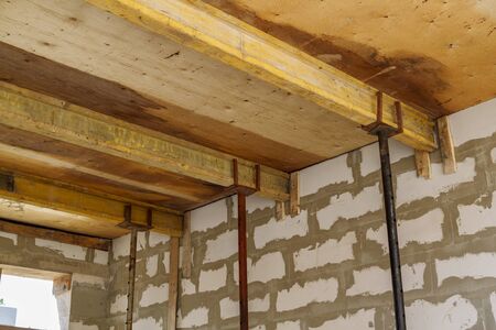 close up view of the wooden formwork with metal holders, which will be filled with the overlap...